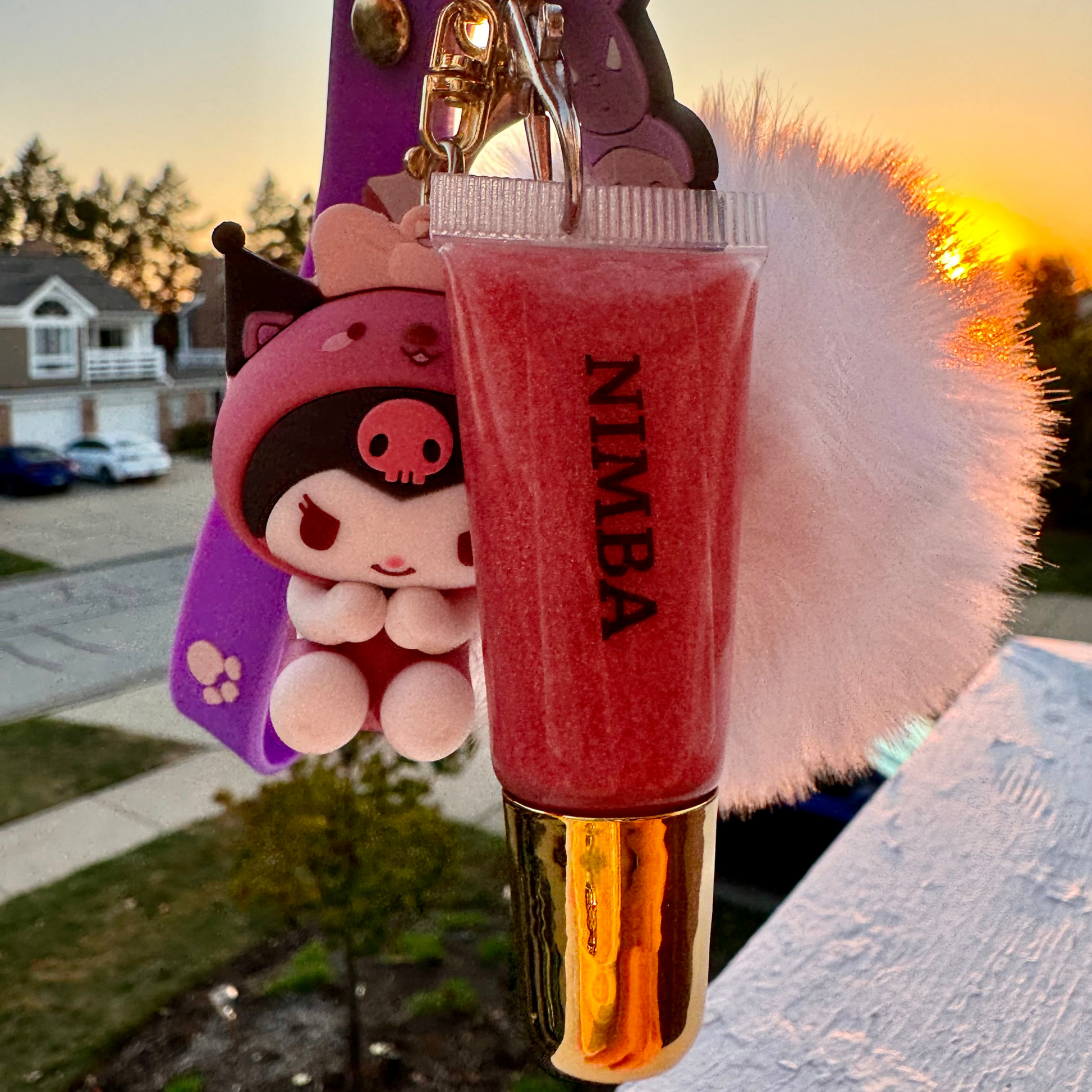 NIMBA pink hydrating lip gloss keychain with a paw print charm, heart keyring, and vegan-friendly formula for natural beauty lovers